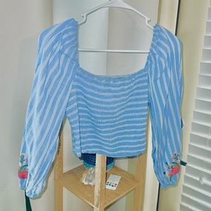 Ruched girly blouse with floral appliqué on sleeve